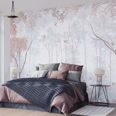 a bedroom with a bed, nightstands and wallpaper that has trees on it