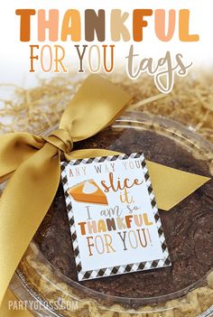 an image of a thank card for you tags on a glass plate with gold ribbon