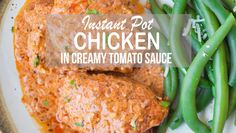 chicken in creamy tomato sauce on a plate with green beans