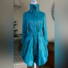 Samual Dong Absolutely Stunning Turquoise Rain Coat And Also Can Be Used As Just A Dress. See Pictures. Worn Once. Amazing Condition And Absolutely Beautiful. Zip Up And Snap Up Closure As Well As Around The Neck Area. The Zipper Stops Inside The Coat A Few Inches Before The Last Snap Closure - This Is For Easier To Sit And Cross Your Legs With Ease. Bought This Beauty In Palm Beach In Florida At A Boutique. The Bottom “Puckers” Like You See In Pictures. It’s Absolutely Brilliant! Blue Silk Outerwear For Work, Blue Silk Outerwear For Fall, Turquoise Long Sleeve Outerwear For Spring, Turquoise Outerwear For Work In Fall, Turquoise Long Sleeve Outerwear For Work, Beach In Florida, Rain Coat, Coat Dress, Palm Beach