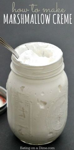 a jar filled with marshmallow creme next to a spoon on a table