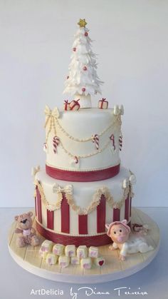 a three tiered cake decorated with christmas decorations