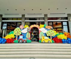 an entrance to a building decorated with balloons