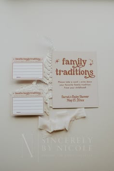 the wedding stationery is laid out on top of each other, including two baby diapers