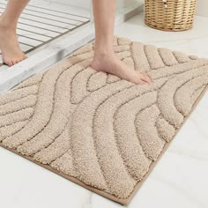 a person standing on top of a bathroom rug