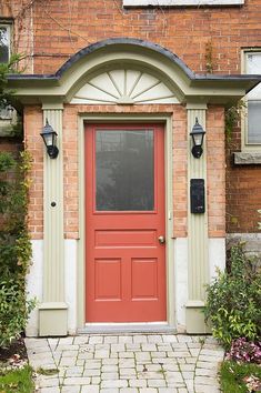 a brick house with a red front door stock photo