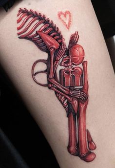 a tattoo on the leg of a person with a horse and skeleton in red ink