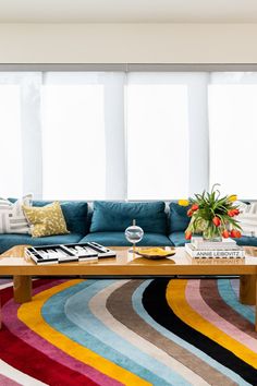 a living room filled with furniture and colorful rugs