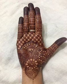 the hand is decorated with henna designs on it