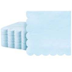 a stack of blue paper napkins with scalloped edges on white background photo