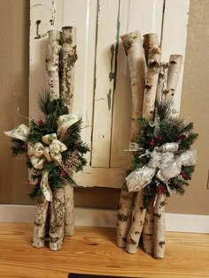 two christmas wreaths made out of tree trunks