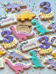 decorated cookies are arranged on a white surface