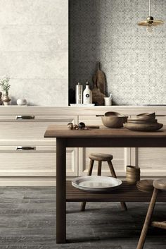 a wooden table with plates and bowls on it