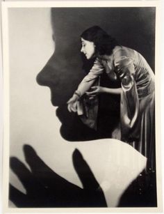 a black and white photo of a woman's shadow