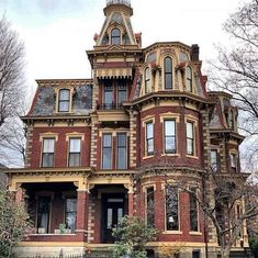 an old victorian style house with many windows