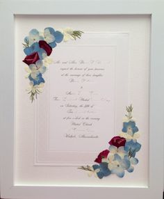 a white frame with blue and red flowers on it