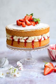 a cake with strawberries and whipped cream on top