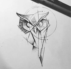 an owl is drawn on paper next to a pen and inking it's face