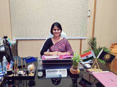 a woman sitting at a desk in an office