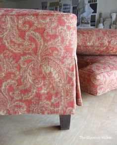 an upholstered chair and footstool are sitting on the floor next to each other