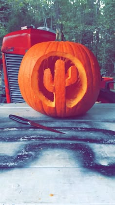 a pumpkin carved to look like the letter p is sitting in front of a tractor