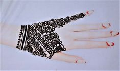 a woman's hand with black and white lace on it