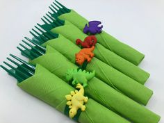 green napkins with small plastic dinosaurs on them