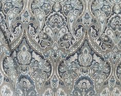 an ornate blue and silver fabric with paisley patterns