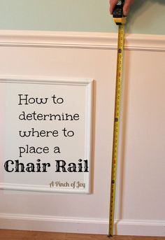 a person holding a measuring tape in front of a sign that says how to determine where to place a chair rail