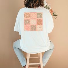 This stunning ladies oversized t-shirt, a perfect blend of style and comfort. This unique piece features a Matisse-inspired print that beautifully combines checkered patterns with delicate flowers, creating a look that is both artistic and chic. Made from high-quality, soft fabric, this t-shirt offers a relaxed fit that is perfect for everyday wear or dressing up for a special occasion. Made using 100% US cotton that is ethically grown and harvested. Gildan is also a proud member of the US Cotton Trust Protocol ensuring ethical and sustainable means of production. This tee is certified by Oeko-Tex for safety and quality assurance. For an oversized look we recommend going at least 2-3 sizes up! Oversized Floral Print T-shirt For Spring, Trendy Oversized Floral Print Tops, Oversized White Floral Print Shirt, Oversized Cotton Floral Print Shirt, Oversized Pink Floral Print Top, Oversized Cotton Tops With Floral Print, White Floral Print T-shirt Relaxed Fit, White Floral Print Relaxed Fit T-shirt, Vintage White Tops With Plant Print