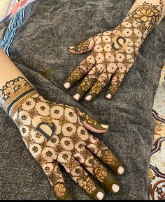 two hands with henna designs on them