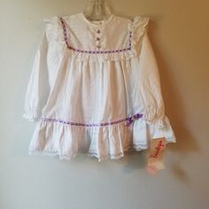 "- This lovely vintage dress by Beautique is ready to be worn! It is white with long sleeves and buttons at back of neck. There is a textured stripe in white as well on fabric. The yoke is trimmed in purple ribbon with white lace ruffles that are mimicked at the hem. There is white lace trimming the bottom of hemline as well. This dress sold new at PixieLand in Michigan. Size: 2t Length: 17.5\"	in stock	38.25 USD	"	0.00 USD	Clothing > Girls' Clothing > Dresses
https://i.etsystatic.com/6769639/r/ Cute Fitted Vintage Long Sleeve Dress, Cute Fitted Vintage Dress With Long Sleeves, Cute Fitted Long Sleeve Vintage Dress, Fitted Long Sleeve Vintage Dress, Cute Style, Cute White Vintage Dress With Lace Trim, White Vintage Long-sleeve Dress With Lace Trim, White Vintage Long Sleeve Dress With Lace Trim, Long Sleeve Cotton Vintage Dress With Ruffles, White Long Sleeve Prairie Dress