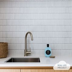 a kitchen counter with a sink, faucet and soap dispenser