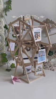 an origami ferris wheel with pictures and photos on the front, attached to it