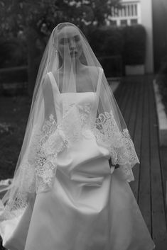 black and white photograph of a bride in her wedding dress with veil on the head