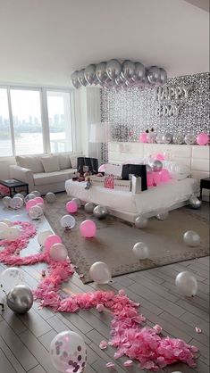 a living room filled with lots of balloons and confetti