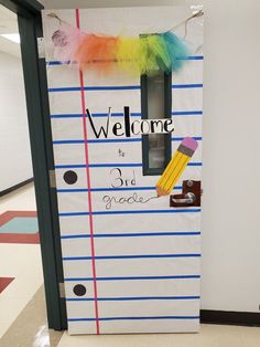 a door decorated to look like a school locker with the words welcome and colorful feathers on it