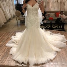 a woman taking a selfie in her wedding dress