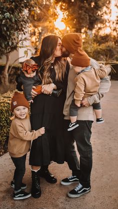 a mother and her two sons are posing for a family photo