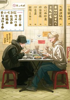 two people sitting at a table eating food