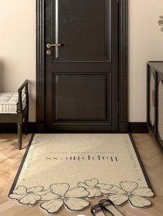 a pair of scissors sitting on top of a rug in front of a black door