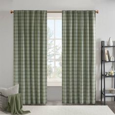 a living room scene with focus on the window curtain and rug in front of it