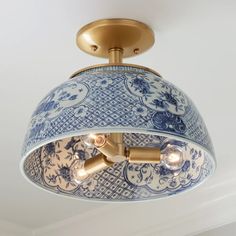 a blue and white light fixture hanging from the ceiling