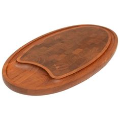 an oval wooden cutting board on a white background