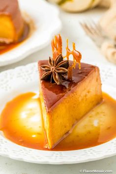 a piece of cake on a white plate with caramel sauce and anise star