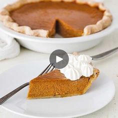 a slice of pumpkin pie on a white plate with a fork in front of it