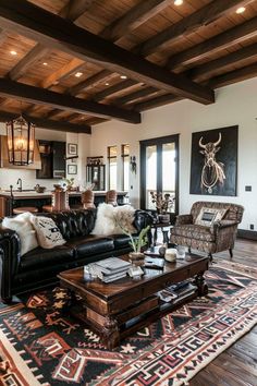 a living room filled with furniture and lots of wood beams on the ceiling, along with an area rug