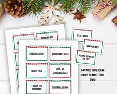 three christmas printables on top of a table next to presents and pine cones