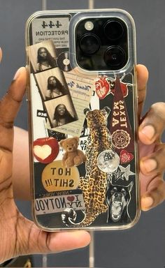 a person holding up a cell phone case with pictures and stickers all over it