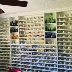 a room filled with lots of white shelves and bowls on top of it's sides